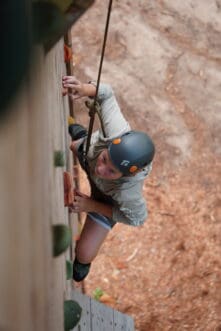 boy with helmet climbing.