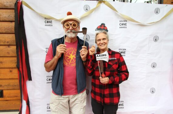 man and women posing for camera with props.