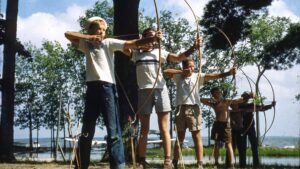 boys ready to fire bows in a line.