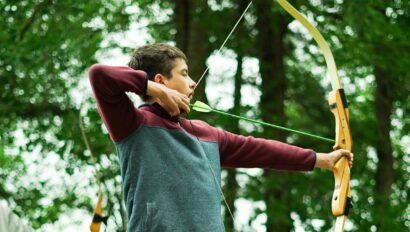 boy pulling back bow.