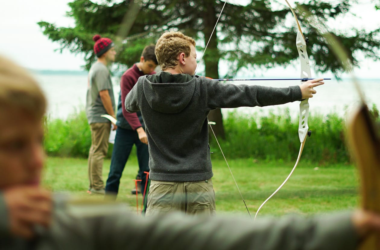 boys firing bows.