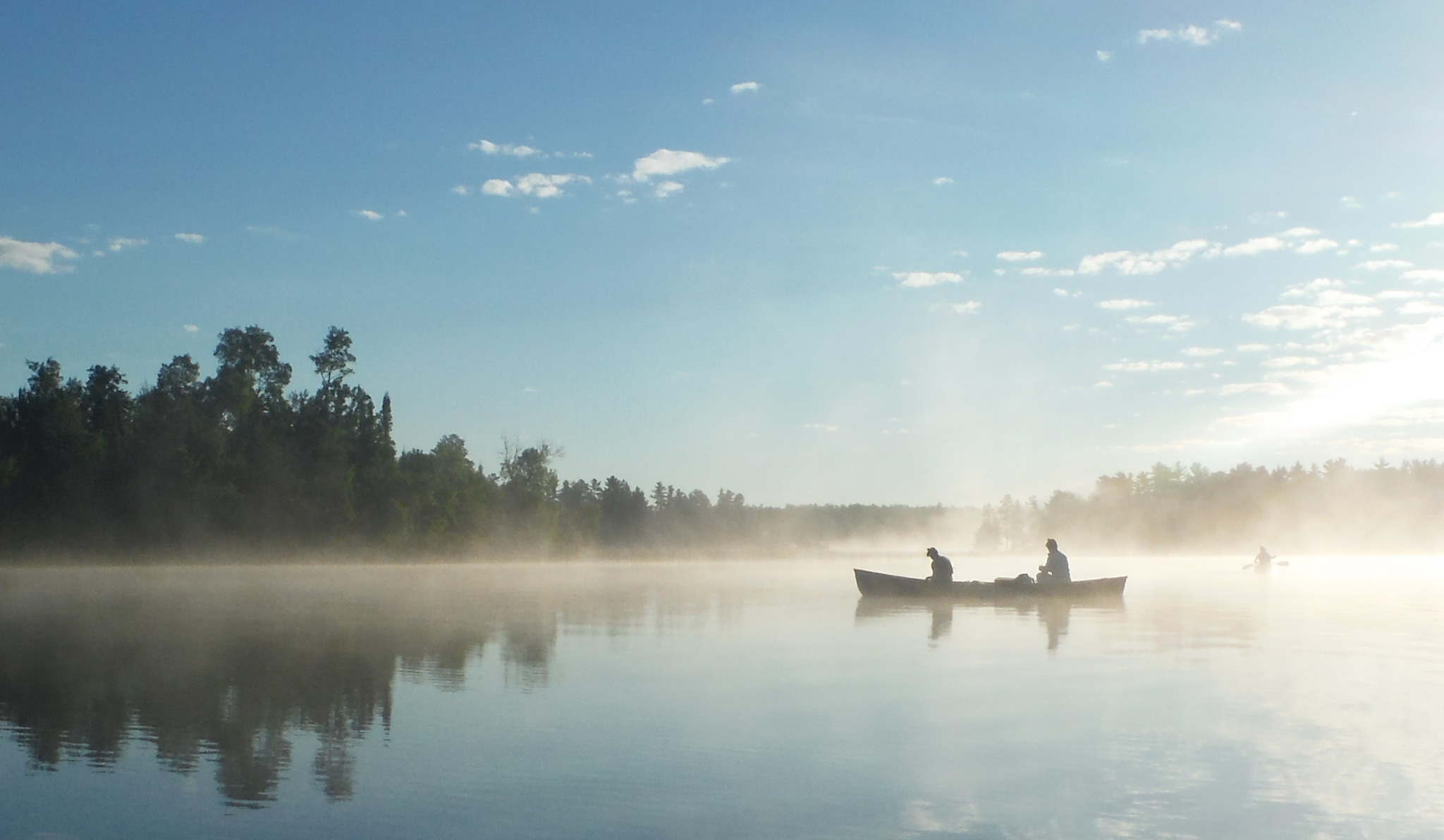 canoe on a misty lake.