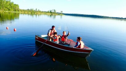 boys on fishing boat on water.