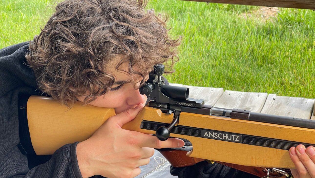 boy shooting rifle.