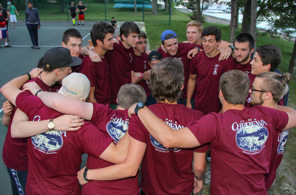 camp counselors in a huddle.