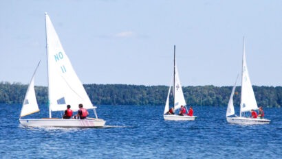 three sailboats on the water.