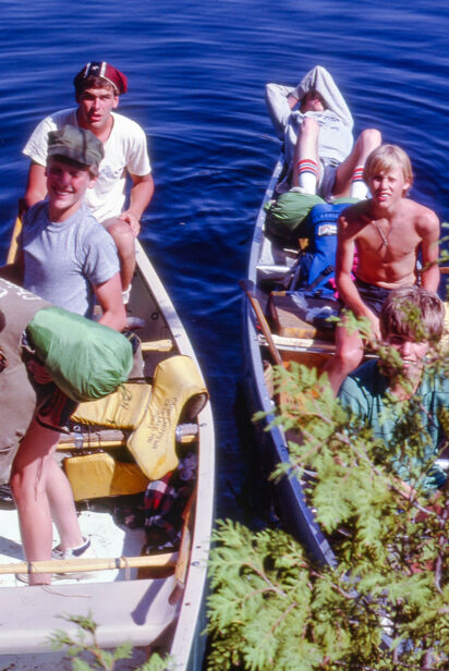 old picture of two canoes full of boys.