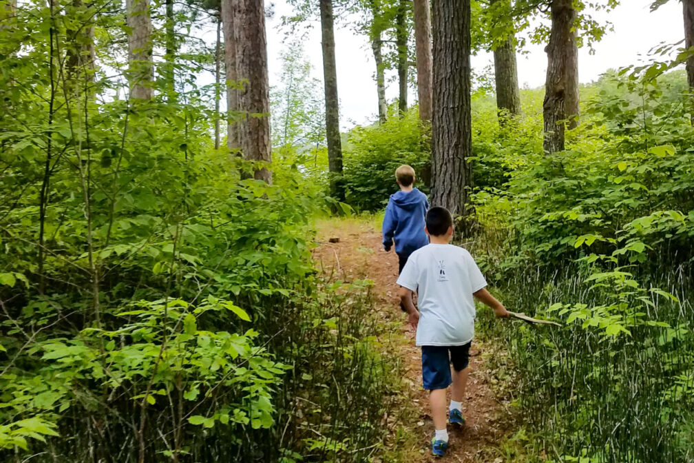 boys running through the woods.