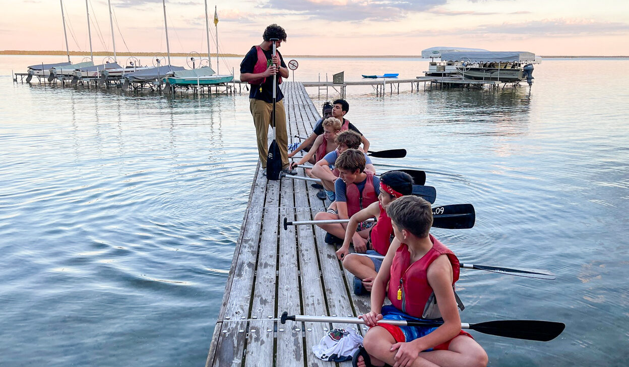 A. young boy leading a canoe training.