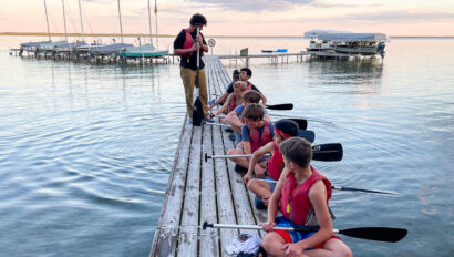 A. young boy leading a canoe training.