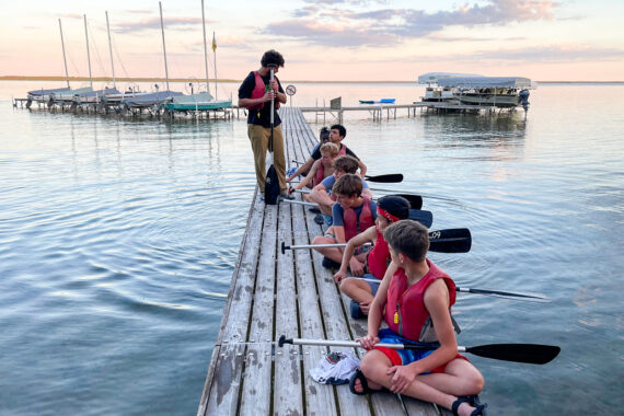 A. young boy leading a canoe training.