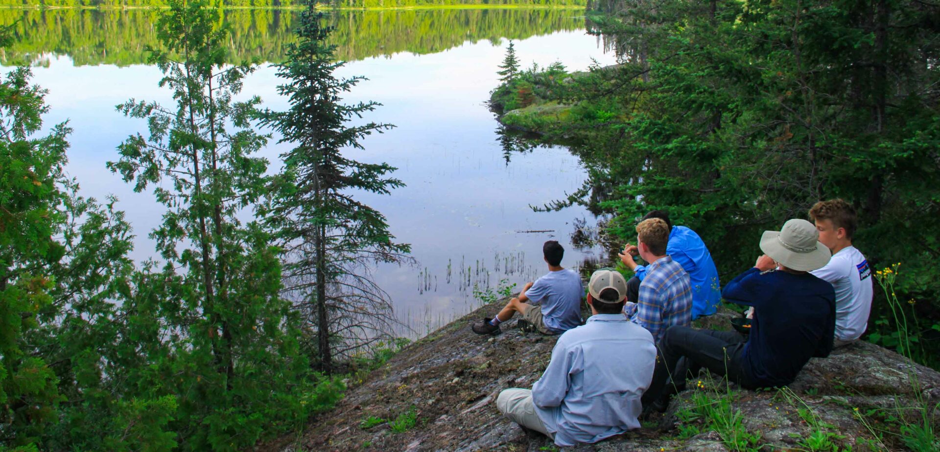 boys overlooking a river.