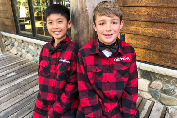 Two boys wearing flannels and bow ties.
