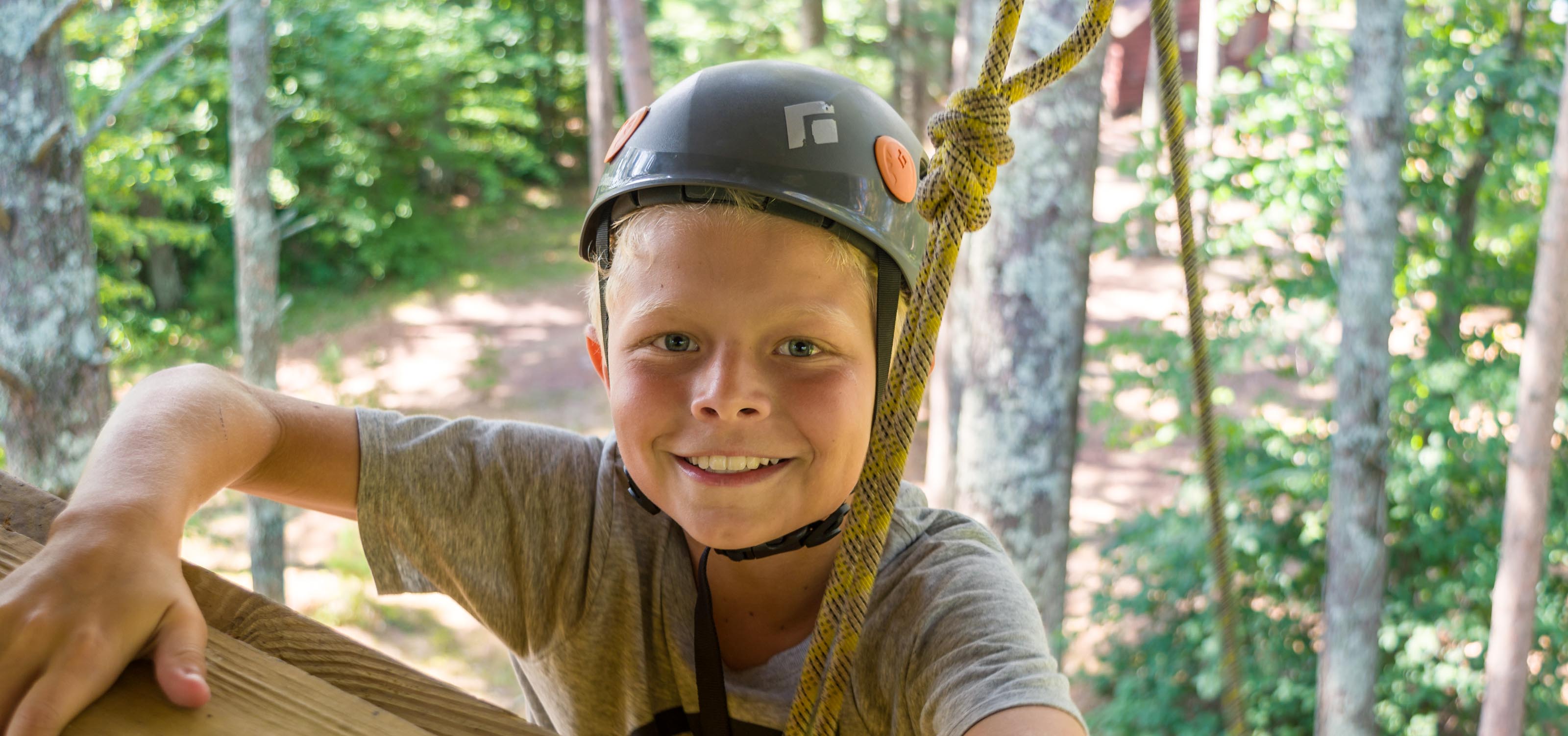 smiling climber at the top of a wall.