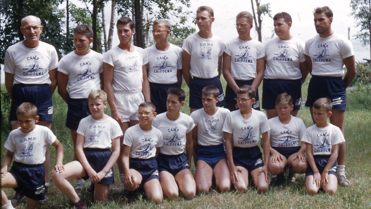 A vintage picture of boys in their camp uniforms .