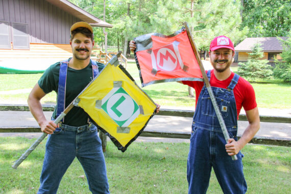 two young men dressed up as mario and luigi.