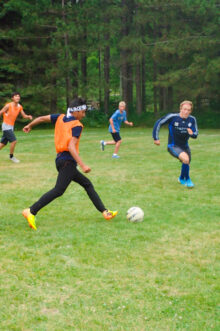 soccer player dribbling down field.