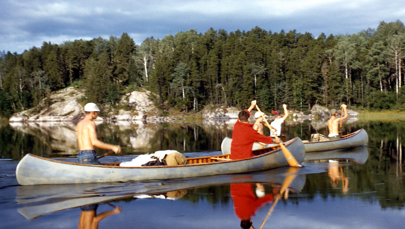 Vintage image of boys canoeing.