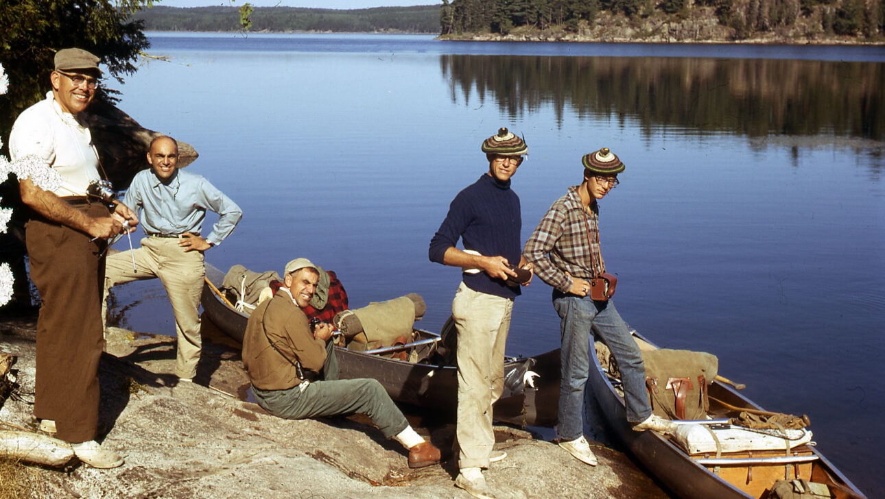 Vintage image of campers on rocks.