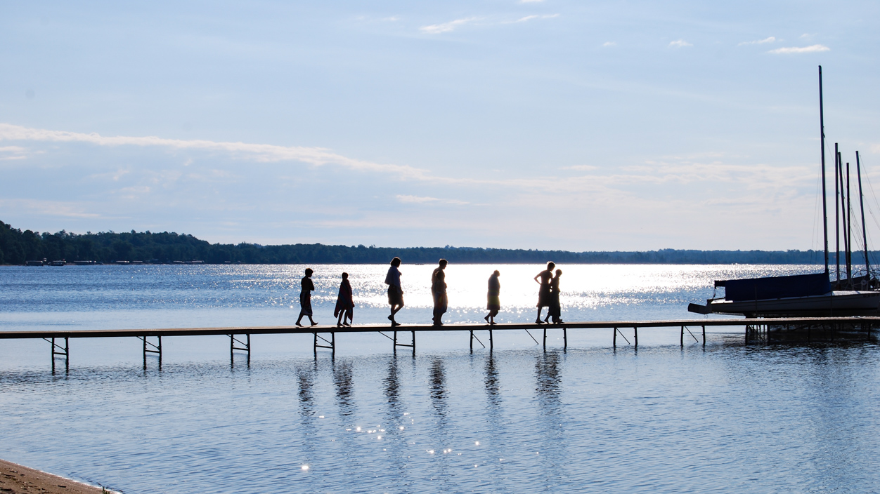 boys walking across a dock i the distance