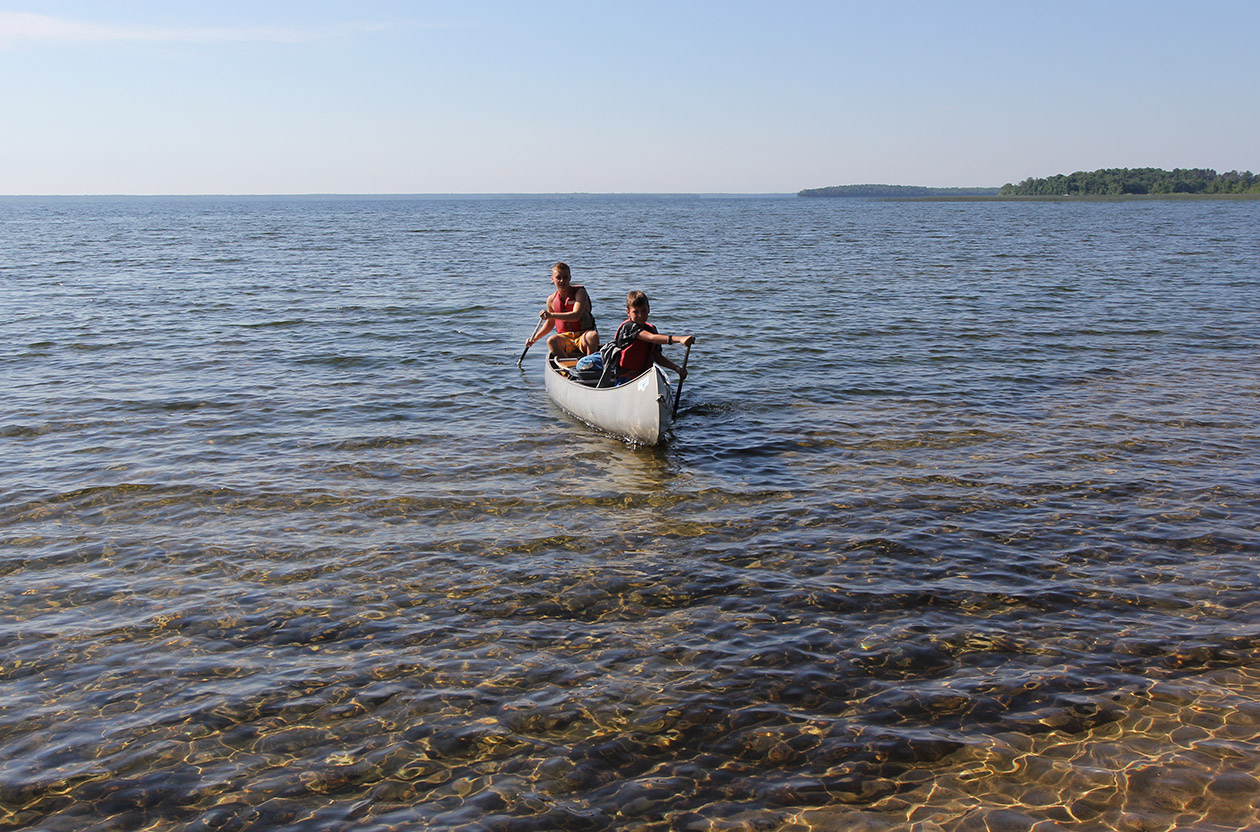 camper and counselor canoeing on Cass Lake.