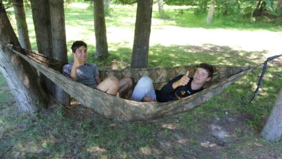 two campers in a hammock.