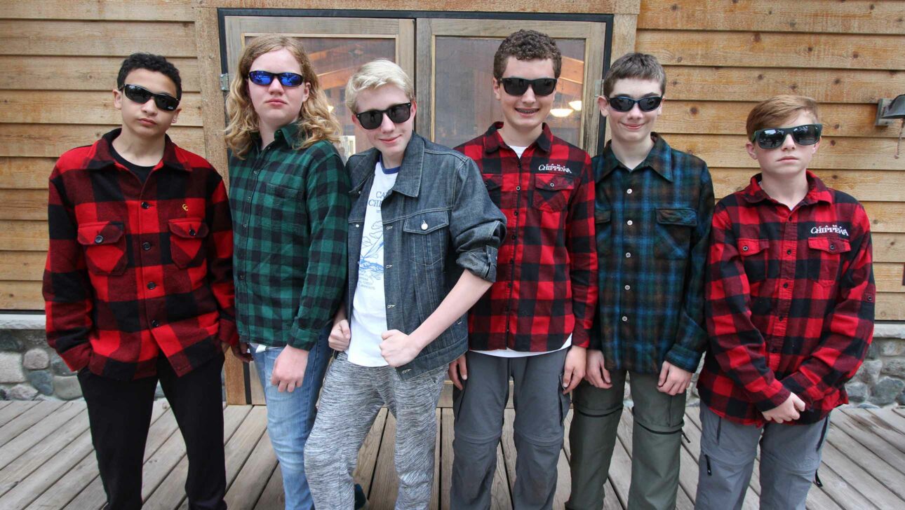 campers dressed in flannel shirts and sunglasses.