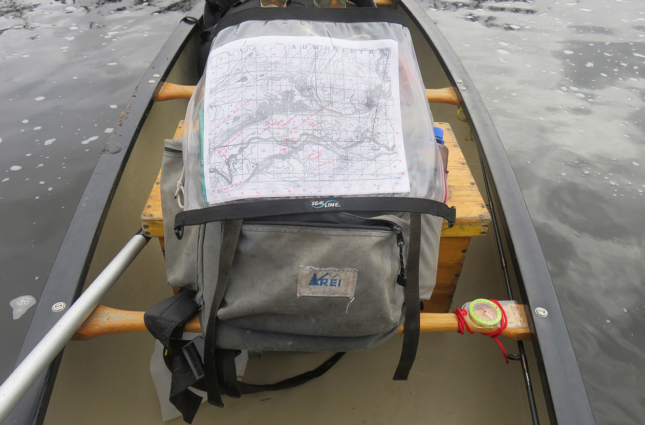 map with canoe route displayed on a pack in a canoe.