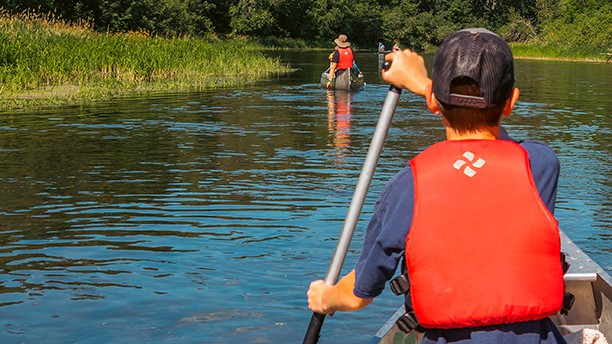 boy canoeing on a river