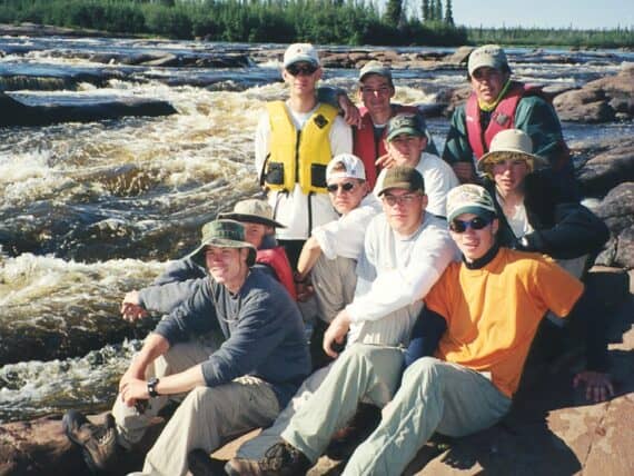 Posing by a set of whitewater rapids in Canada during summer camp.