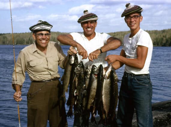 Catching fish on a summer camp canoe trip.