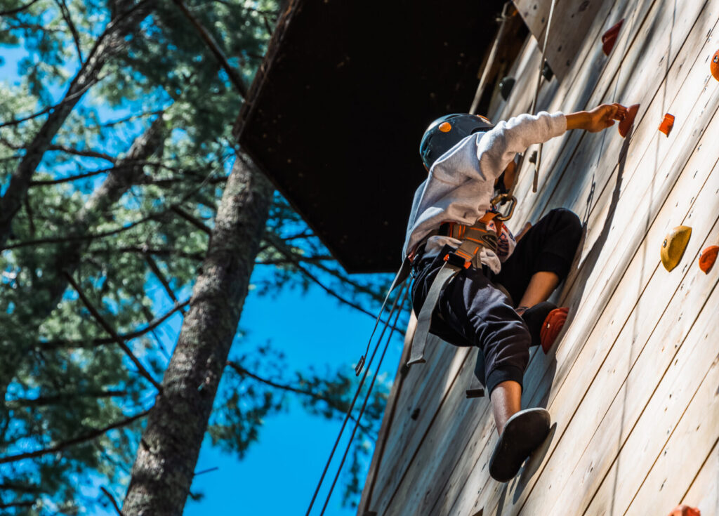 Camper climbing the climbing tower at Camp Chippewa.