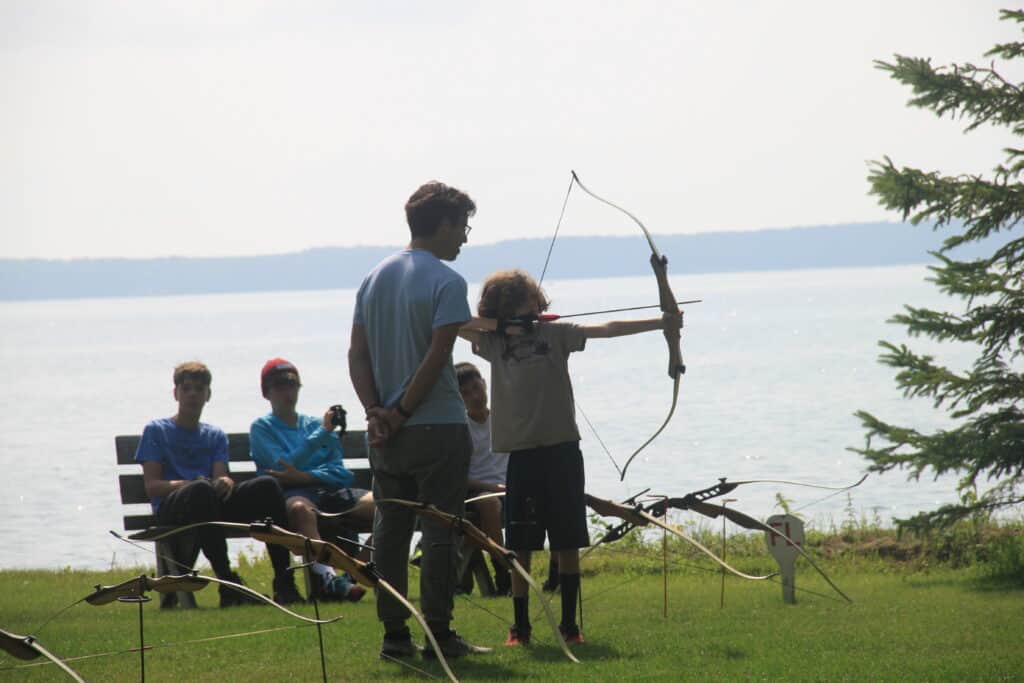 Teaching archery to summer camp campers by Cass Lake in Minnesota.