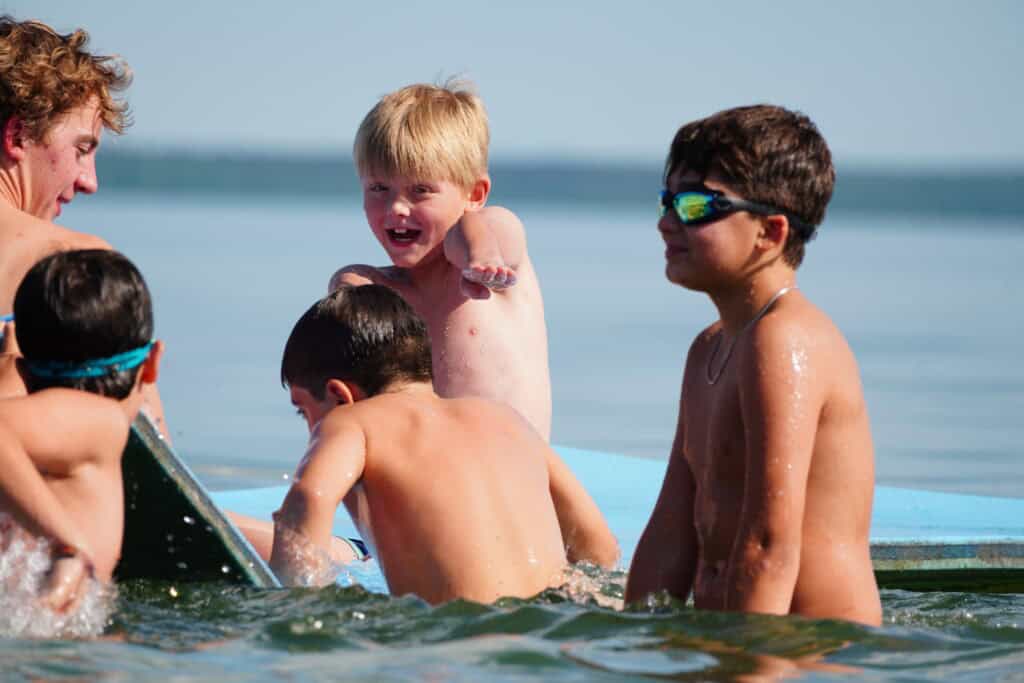 campers play in the lake