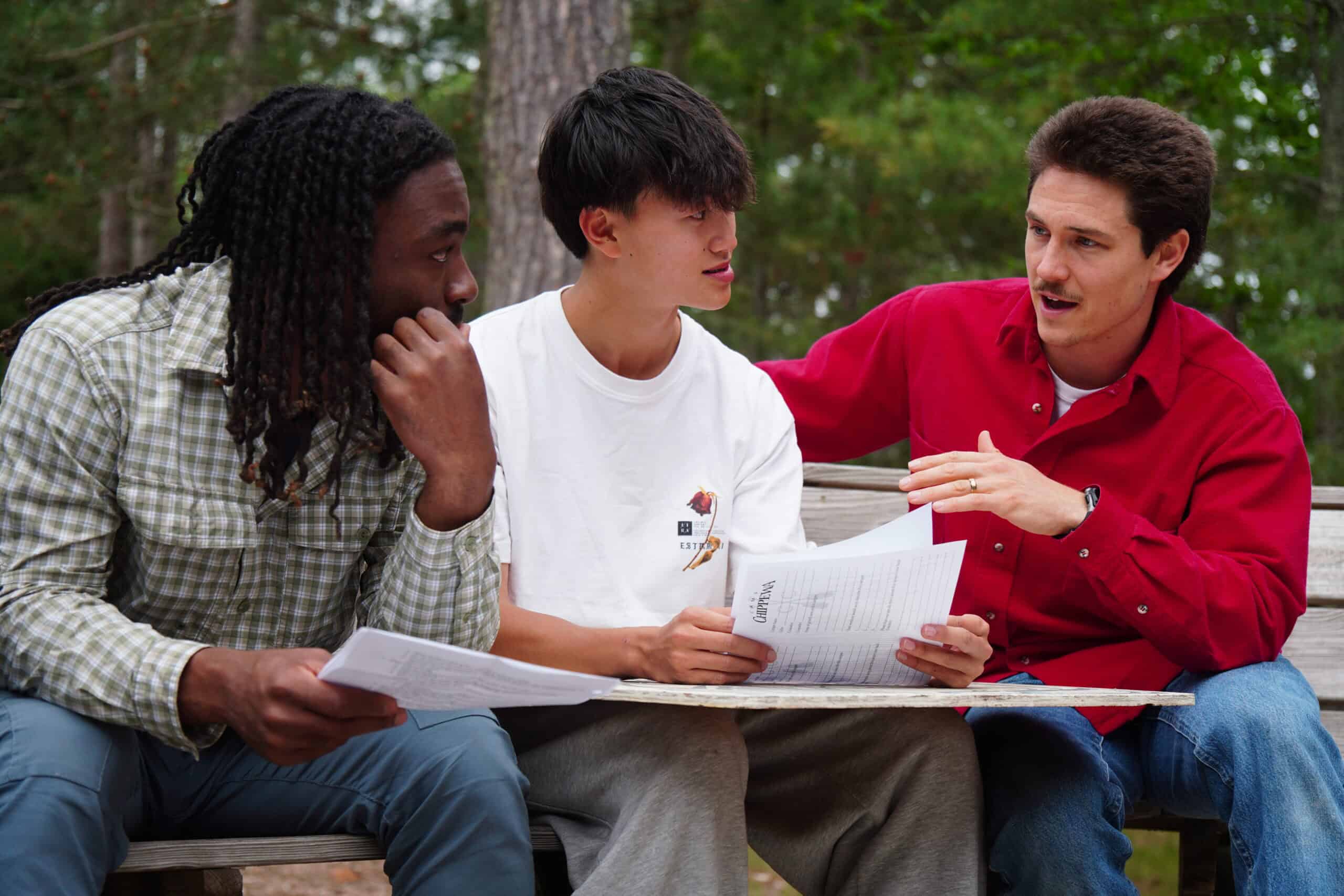 one adult working with two other adults.