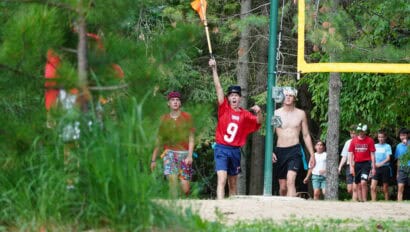 smiling boy holding flag during capture the flag.