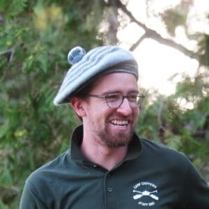 counselor with tam smiling at summer camp.